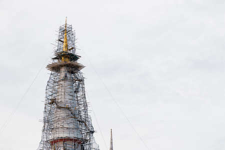 golden peak of the large pagoda that is being restoration in Thailand