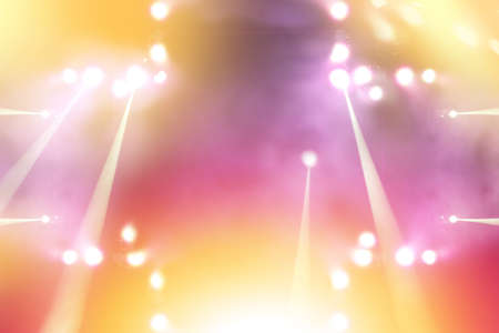 blurred empty theater stage with fun colourful spotlights, abstract image of concert lighting illumination backgroundの写真素材