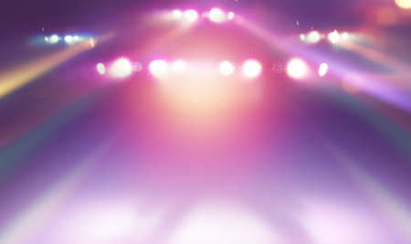 blurred empty theater stage with fun colourful spotlights, abstract image of concert lighting illumination backgroundの写真素材