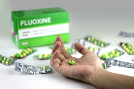 Fluoxetine capsules on a hand (in trademark name is Fluoxine) ; Fluoxetine is a antidepressantのeditorial素材