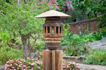 Lamps made of wood in the garden の写真素材