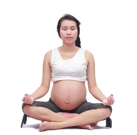 Pregnant woman meditating yoga の写真素材