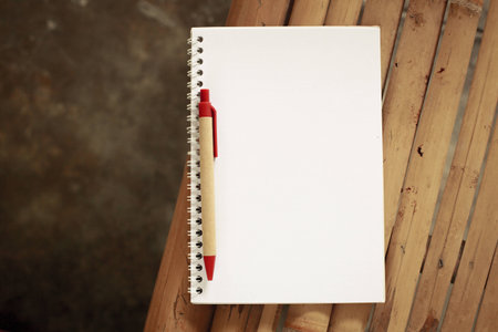 Open notebook on a table made &#8203;&#8203;of Bamboo.の写真素材