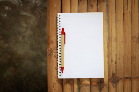 Open notebook on a table made ​​of Bamboo.の写真素材
