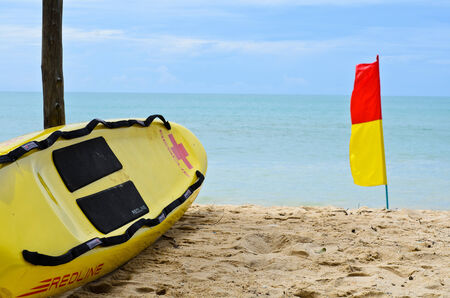 Surf Rescue surfboard and flags on Naiharn beach, Phuket Thailandのeditorial素材