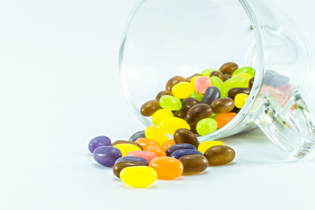 jelly bean in a glass on white backgroundの写真素材