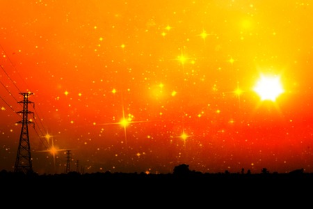High voltage power pole middle of a cornfield with orange sky and galaxyの写真素材