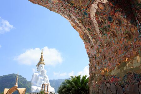 white statue of Buddha with blue sky in the templeの写真素材