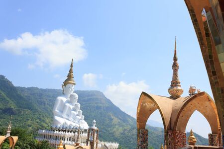 white statue of Buddha with blue sky in the templeの写真素材