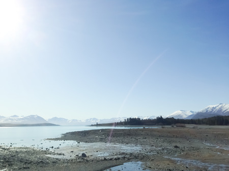 Lake with mountains covered with snowの写真素材