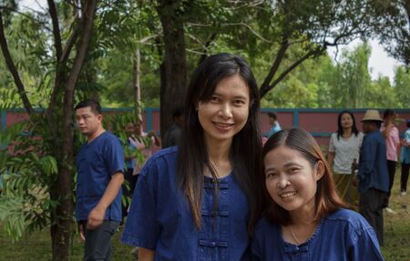 Two women commissioner joined a reforestation students and photographers take pictures as evidence.Thailand,August 2016のeditorial素材