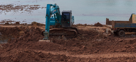 Backhoe're dredging the pond to store water for use during the dry season.Mahasarakham,Thailand,August 2016のeditorial素材
