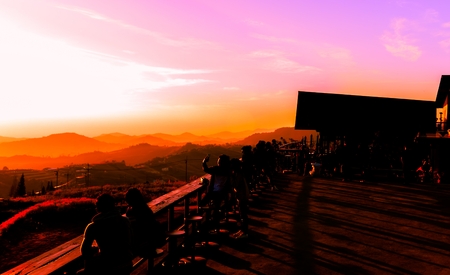 Many tourists watch the morning sunrise on the mountain.の写真素材