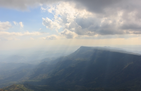 Light from the sun through the clouds into the mountains.の写真素材