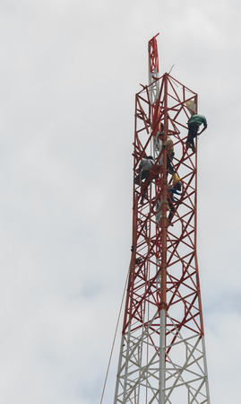 Workers demolition  telephone poles due to health complaints.Mahasarakham,Thailand,July 2016のeditorial素材