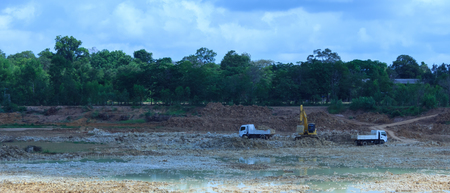 Backhoe're dredging the pond to store water for use during the dry season.Mahasarakham,Thailand,August  2016のeditorial素材