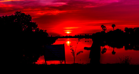 Beautiful sunset behind the pond.の写真素材