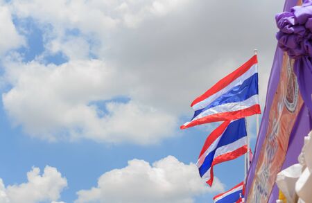 Thai flag on the building with blue sky.