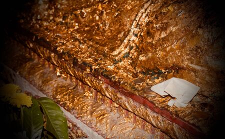 Money for merit on the Buddha statue.の写真素材