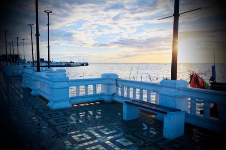 Bench by the sea at sunset.の写真素材