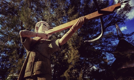 Statue of a hunter in a Thai park.の写真素材