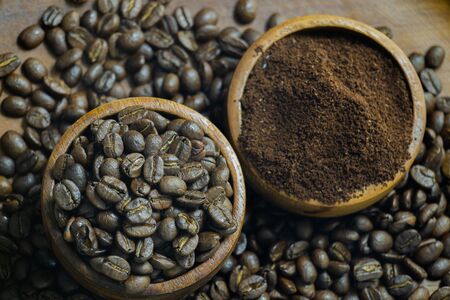 Roasted Coffee beans on grunge wooden can be used as a backgroundの写真素材