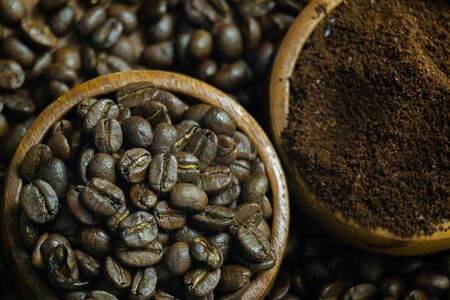 Roasted Coffee beans on grunge wooden can be used as a backgroundの写真素材