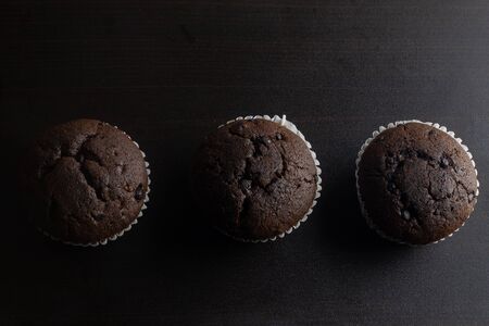 Three inline Cup Cake on wood backgroundの写真素材