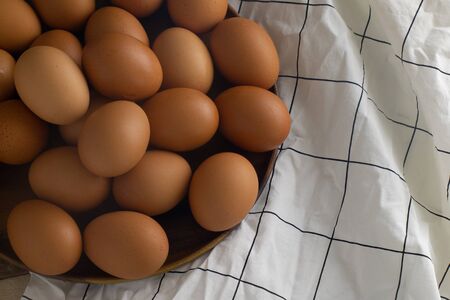 Group Raw Eggs on Wooden Background and White fabricの写真素材