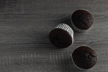 Three Cup Cake on wood background in wide angleの写真素材