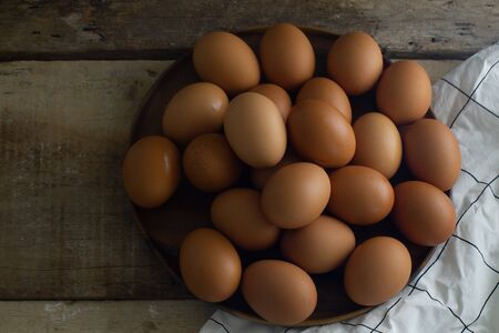 Group Raw Eggs on Wooden Background and White fabric