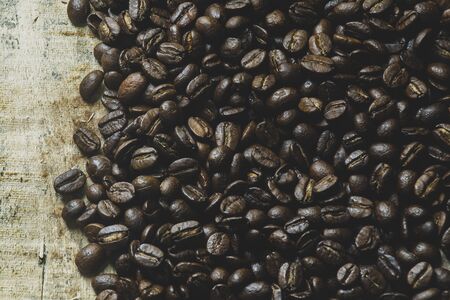 Coffee beans  on wooden backgroundの写真素材