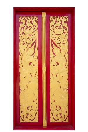 Ancient art pattern on the wooden door in Thai templeの写真素材