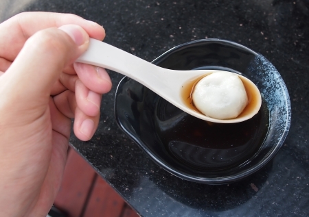 Thai sweetmeat with ball flour of sesame and ginger aleの写真素材