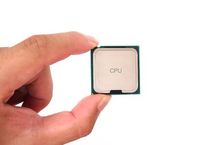 computer processor microchip held between the fingers  isolated on a white backgroundの写真素材