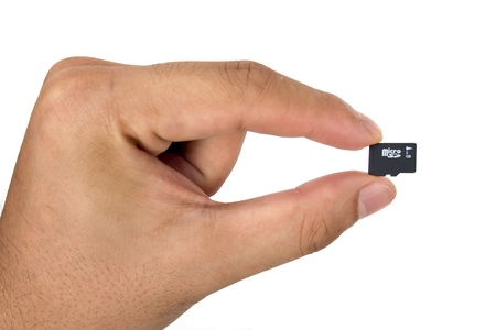 Micro sd memory in hand , isolated on white backgroundの写真素材