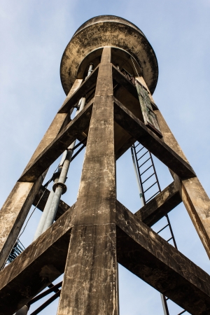 Old water tank tower on blue sky backgroundの写真素材
