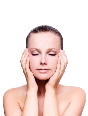 Closeup of human hands massaging a young pretty woman's face の写真素材