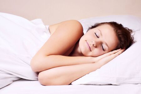 Beautiful woman lying and sleep on the snowy bed 

の写真素材