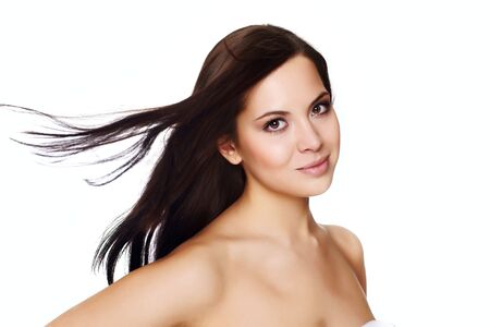 Portrait of a beautiful young woman with hair flyingの写真素材