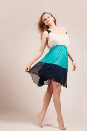 attractive young woman dancing, studio light backgroundの写真素材