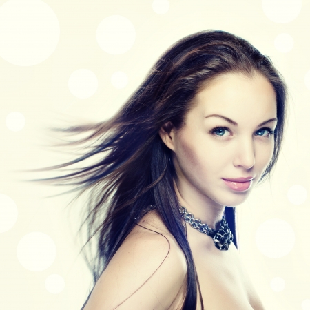 Portrait of a beautiful young woman with hair flyingの写真素材