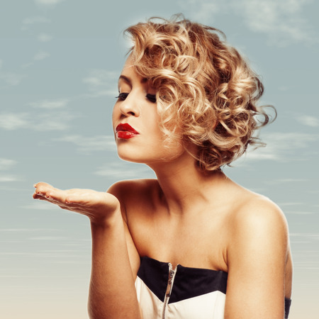 young beautiful blond Female blowing kissed to her valentineの写真素材