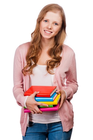 Cute young attractive student girl holding colorful exercise books.の写真素材