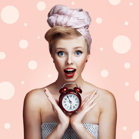 Beautiful young sexy pin-up girl with surprised expression, on white backgroundの写真素材