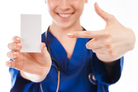 Female nurse, doctor, with beautiful hands give cardの写真素材