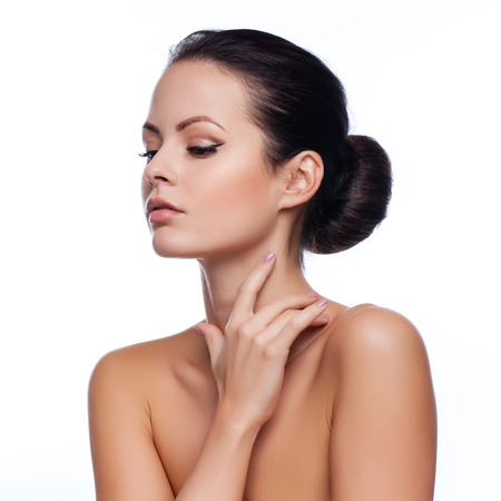 Beautiful Young Woman Touching Her Face.Fresh Healthy Skin.Isolated on Whiteの写真素材