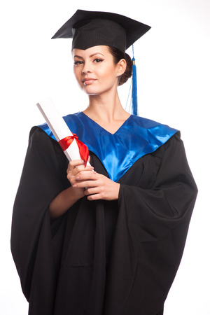 A woman with a degree in her hand as she looks at the cameraの写真素材