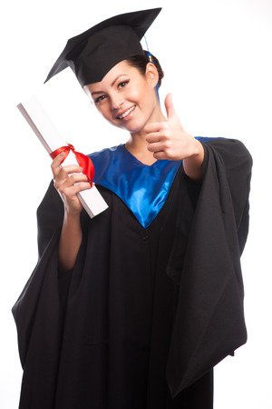 A woman with a degree in her hand as she looks at the cameraの写真素材