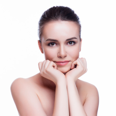 Beautiful face of young adult woman with clean fresh skin - isolated on whiteの写真素材